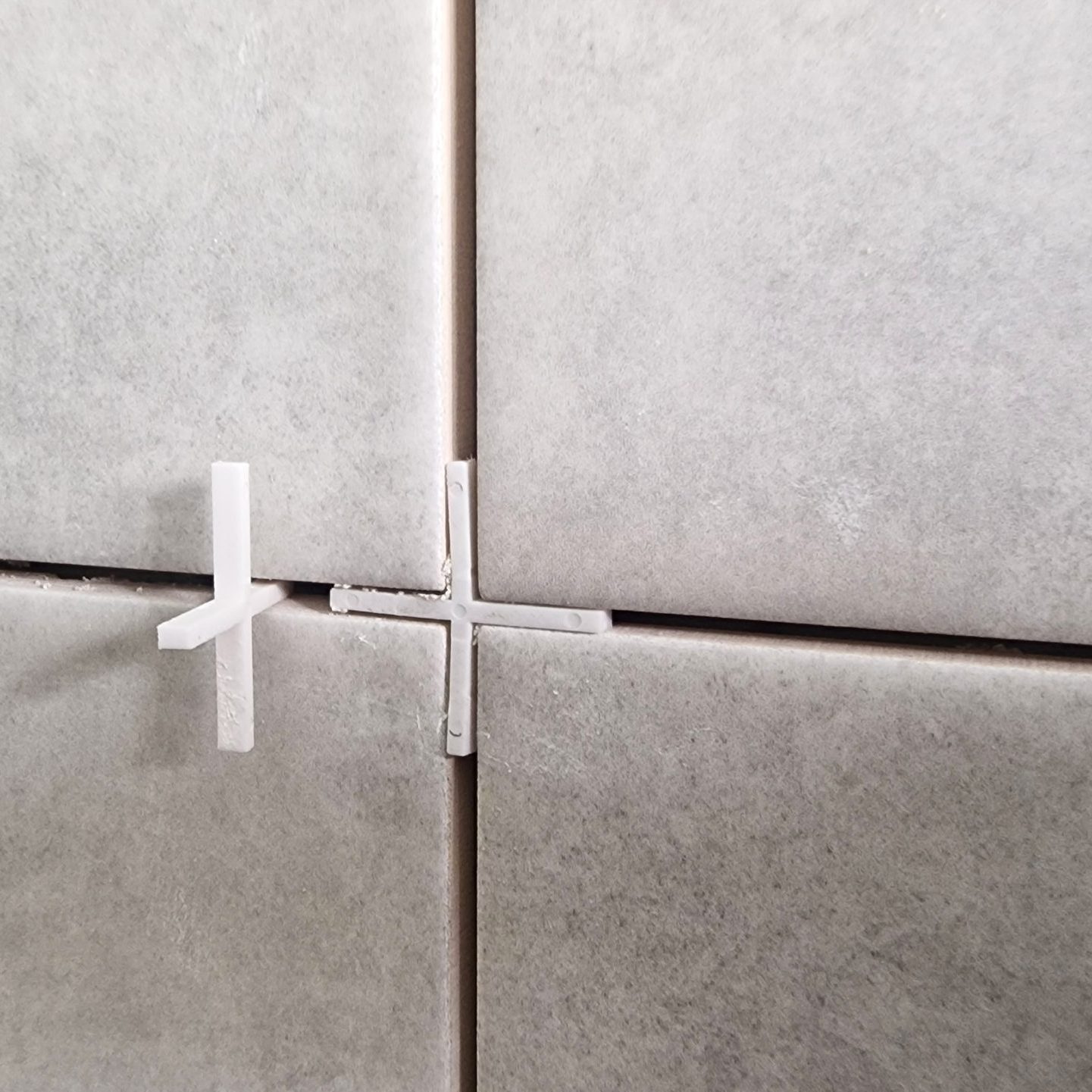 Tiles and tile spacers being installed during renovation